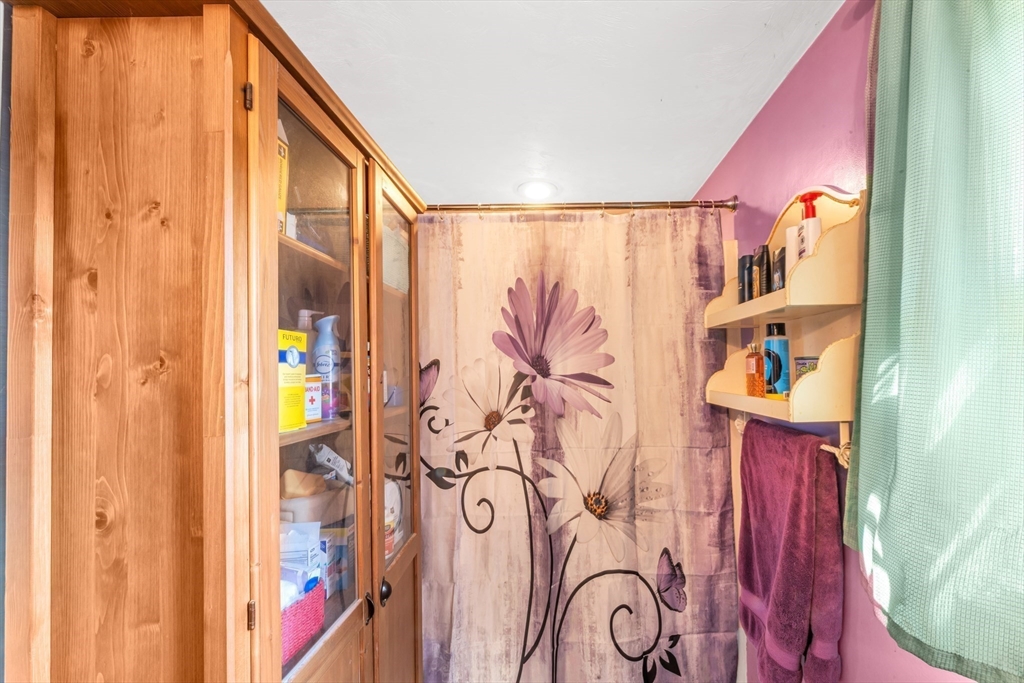 324 Central Avenue Dedham, MA 02026 - Photo 22 of 27 a view of walk in closet with clothes and shoes