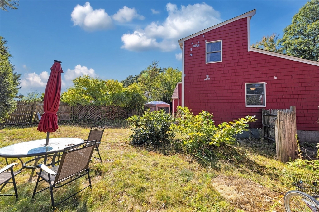 324 Central Avenue Dedham, MA 02026 - Photo 23 of 27 a backyard of a house with a yard and outdoor seating