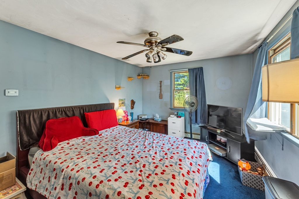 324 Central Avenue Dedham, MA 02026 - Photo 25 of 27 a bedroom with a large bed and a window