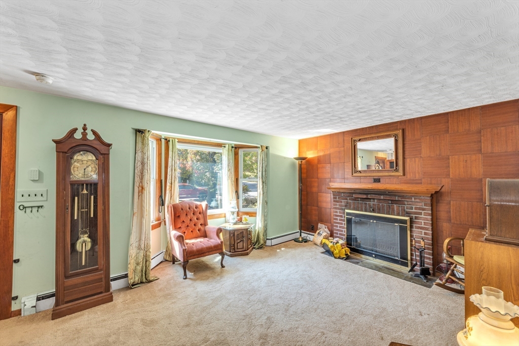 324 Central Avenue Dedham, MA 02026 - Photo 5 of 27 a living room with furniture and a fireplace