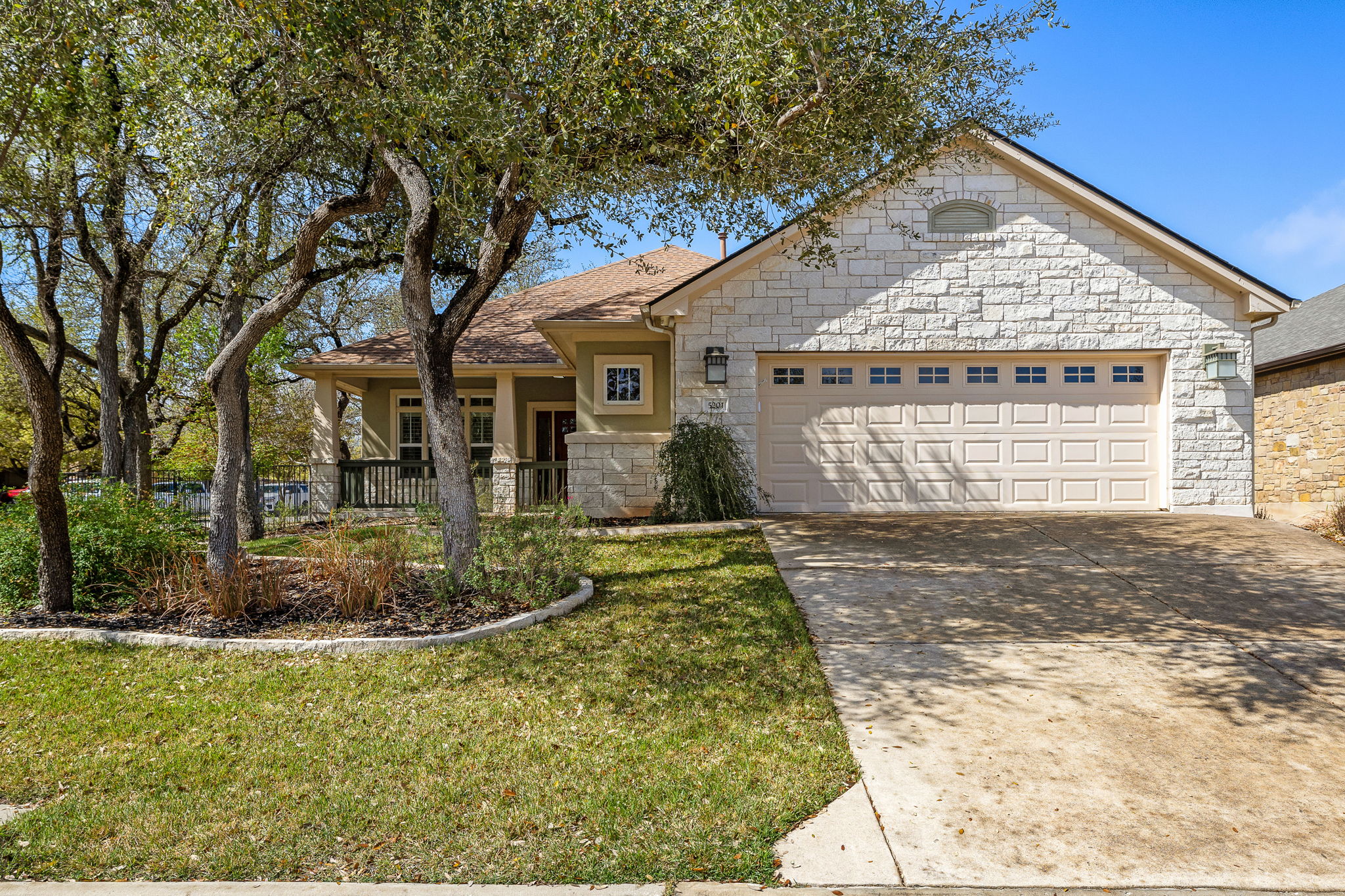 5201 Big Spring Street Georgetown, TX 78633 - Photo 1 of 26 View of front of property featuring stone siding, an attached garage, concrete driveway, and a front yard