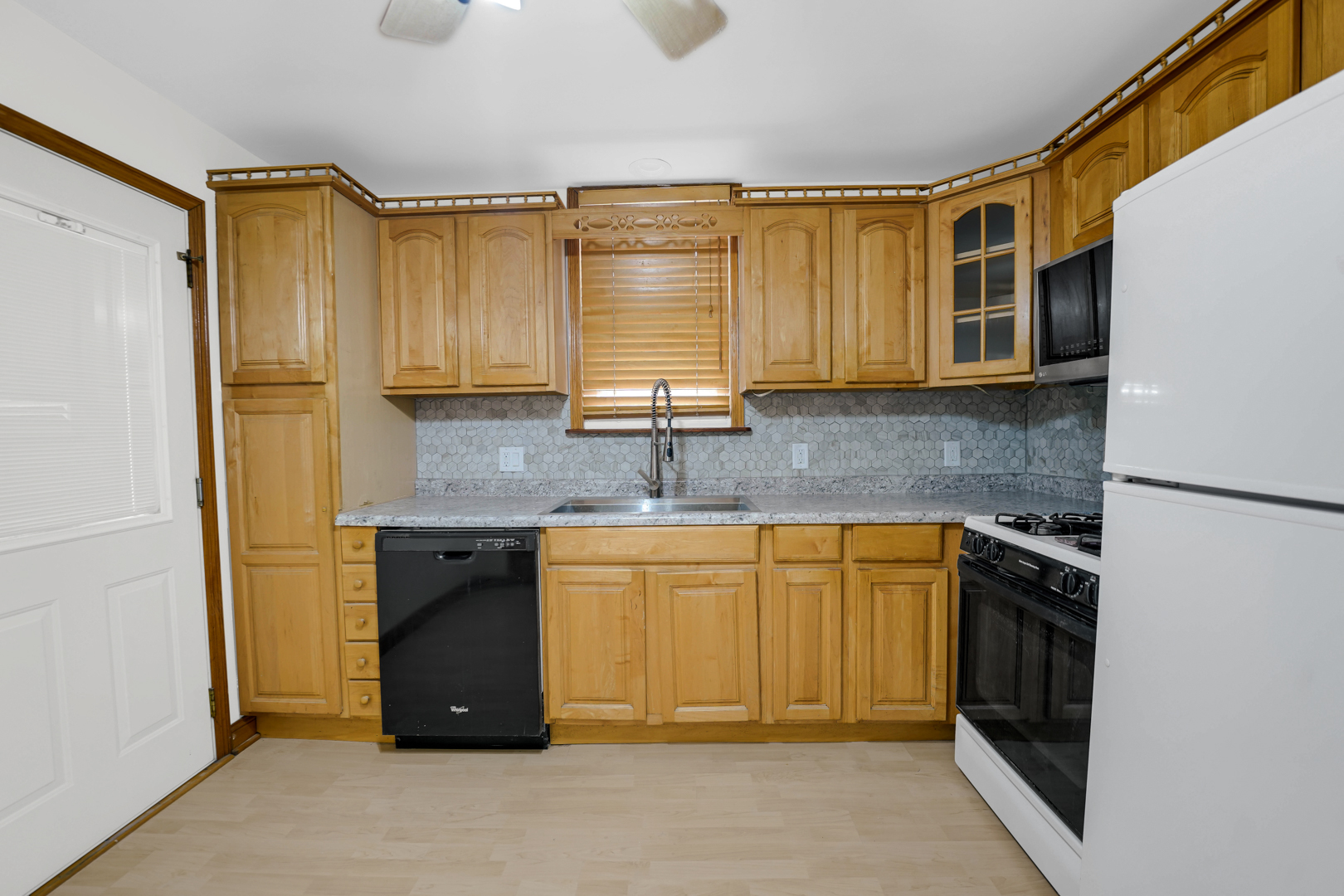 5535 South Kildare Avenue, Unit 1 Chicago, IL 60629 - Photo 10 of 23 a kitchen with granite countertop cabinets stainless steel appliances and a counter space