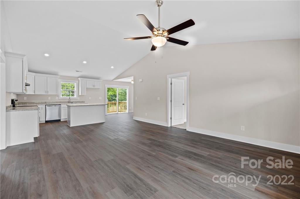 951 Pine Ridge Road, Unit 1 Chester, SC 29706 - Photo 14 of 31 a view of an empty room with wooden floor and a kitchen