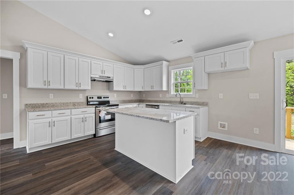 951 Pine Ridge Road, Unit 1 Chester, SC 29706 - Photo 17 of 31 a kitchen with granite countertop white cabinets and white appliances