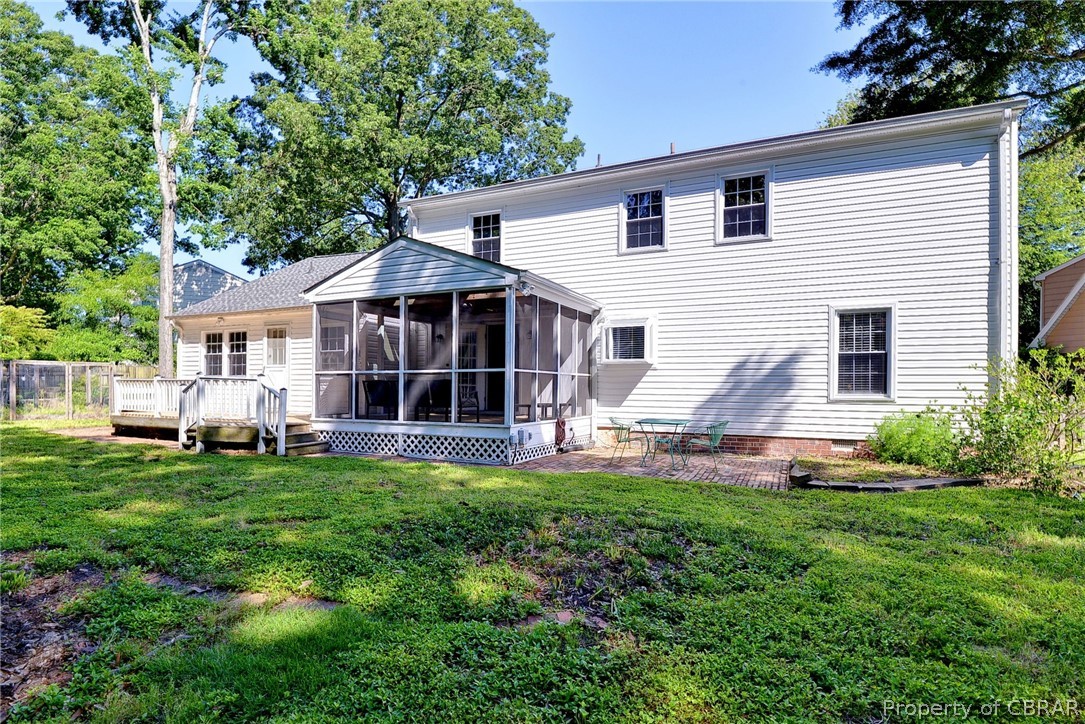 137 Wilderness Road Hampton, VA 23669 - Photo 25 of 45 Back of house with a deck, a sunroom, and a lawn