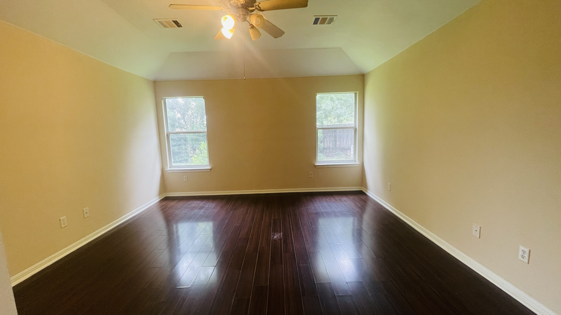 6805 Cromarty Lane Austin, TX 78754 - Photo 11 of 18 a view of an empty room with wooden floor and a window