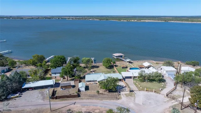 an aerial view of a house with a garden and lake view