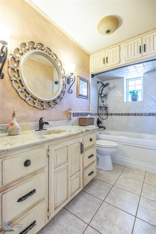 48 Poverty Point Circle Abilene, TX 79601 - Photo 14 of 35 a bathroom with a granite countertop toilet a sink and a mirror