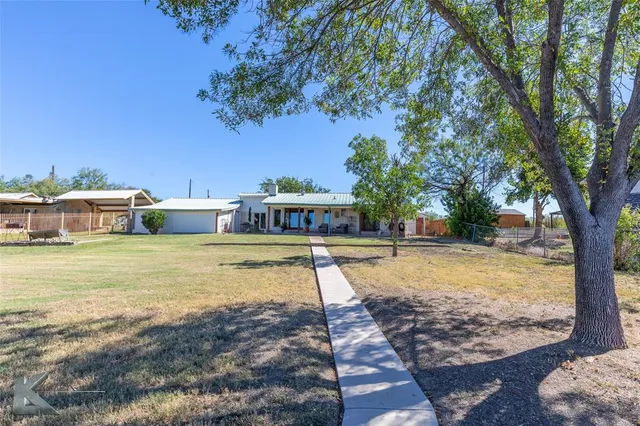a view of a house next to a big yard