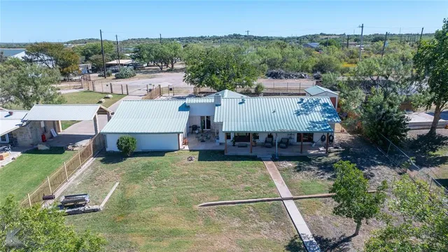 a view of swimming pool with outdoor seating and yard in the back