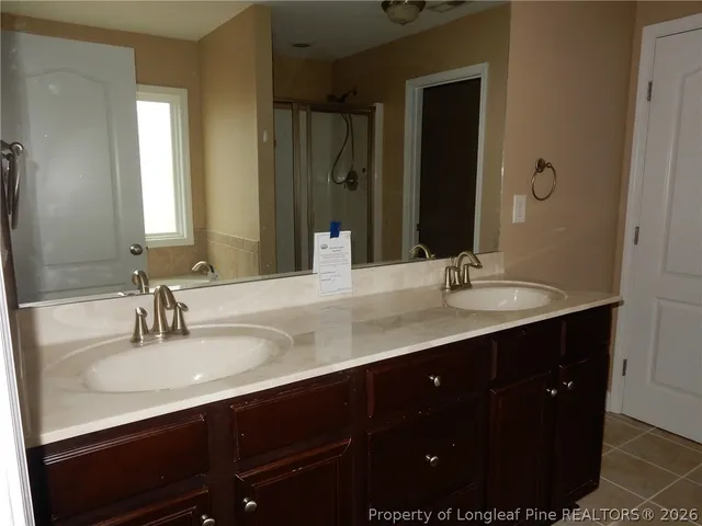 a bathroom with double vanity sink and a mirror