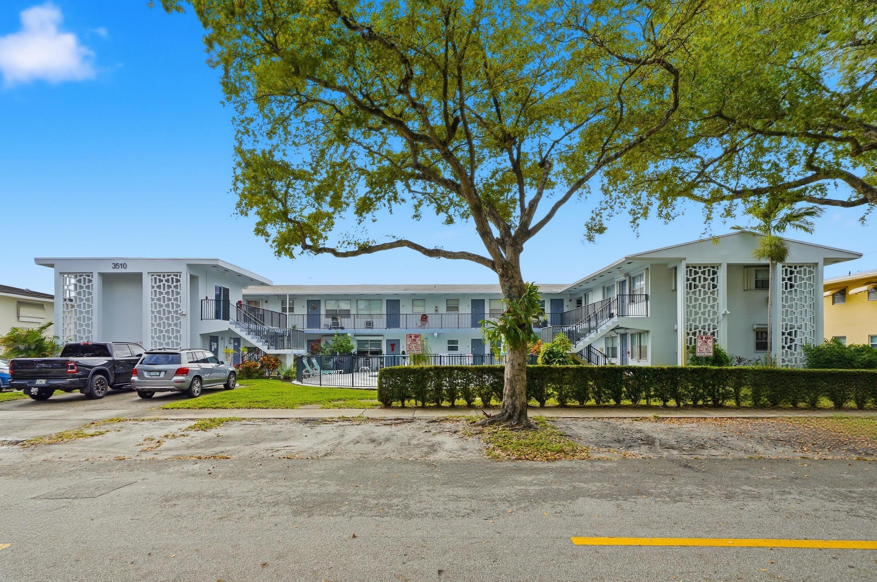 3510 Harrison Street, Unit 4 Hollywood, FL 33021 - Photo 1 of 31 a front view of a building with garden and trees