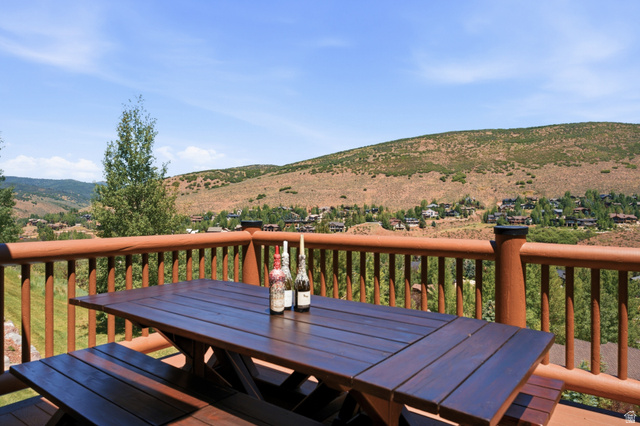 3148 Lower Saddleback Road Park City, UT 84098 - Photo 22 of 67 Expansive outdoor deck featuring a wooden picnic table and bench seating, surrounded by a robust wooden railing
