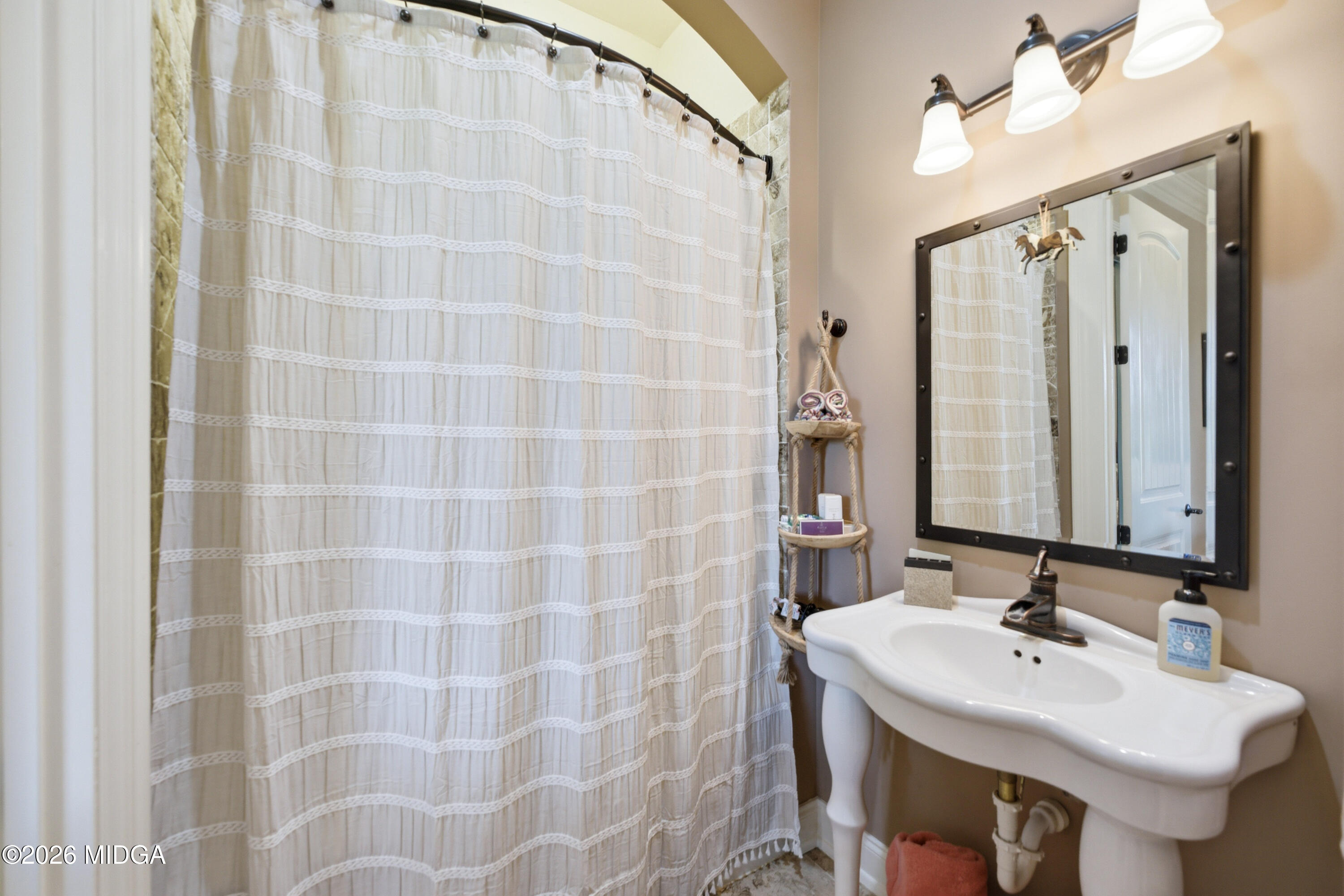 13 Southern Waters Way Forsyth, GA 31029 - Photo 33 of 112 a bathroom with a sink a mirror and a shower