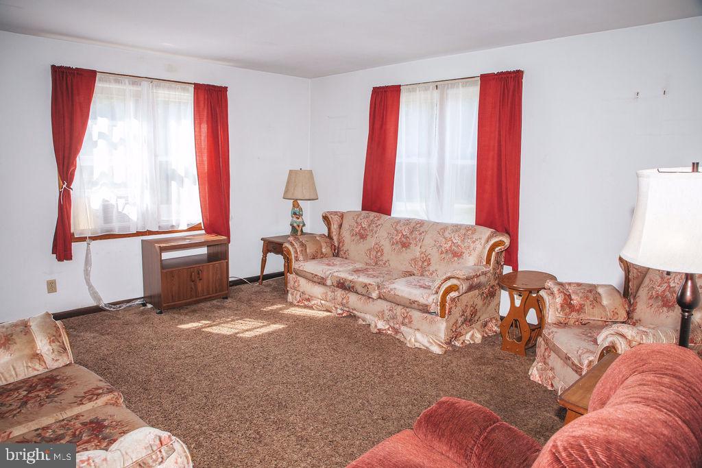 383 Elk Road Monroeville, NJ 08343 - Photo 7 of 25 a living room with a bed furniture and a window