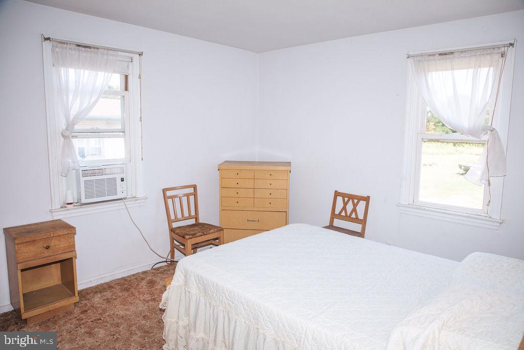 383 Elk Road Monroeville, NJ 08343 - Photo 8 of 25 a bedroom with a bed and wooden floor