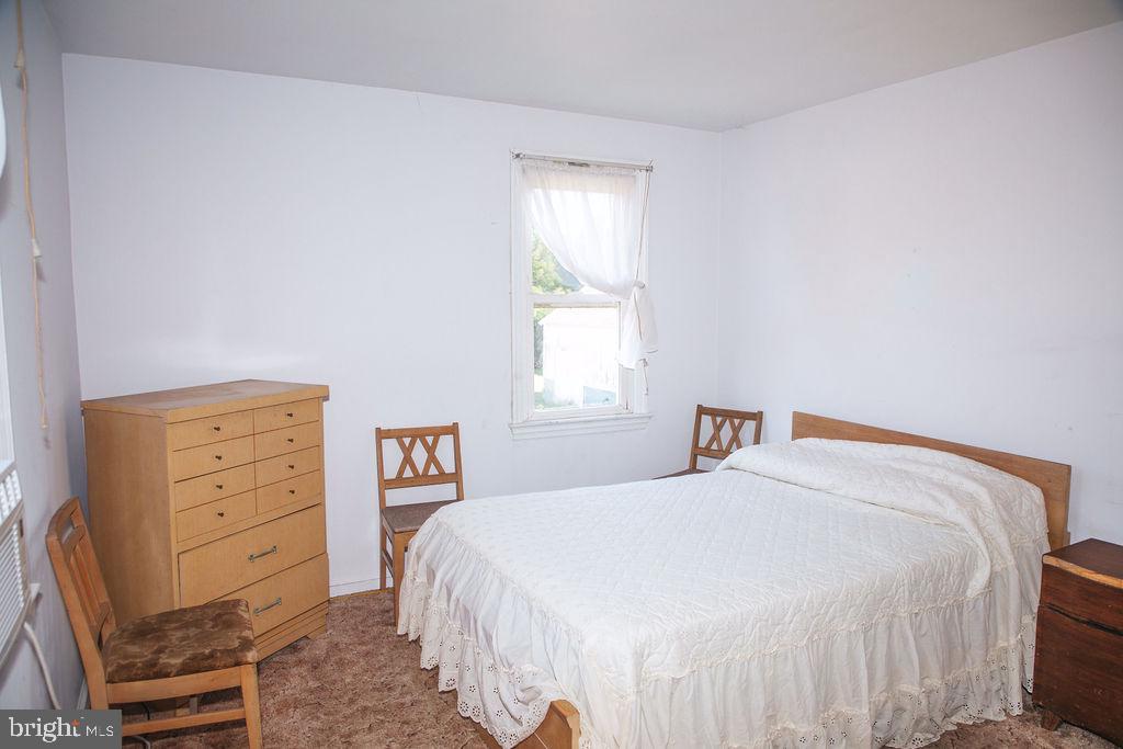 383 Elk Road Monroeville, NJ 08343 - Photo 9 of 25 a bedroom with a bed and a dresser