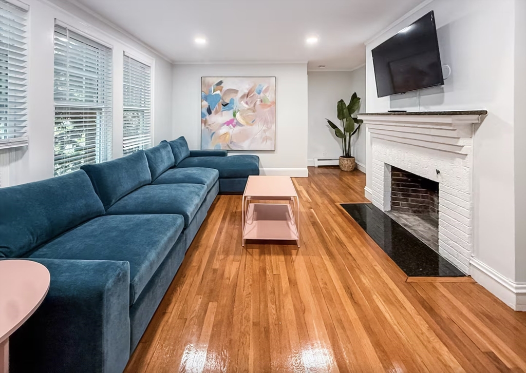a living room with fireplace furniture and a flat screen tv