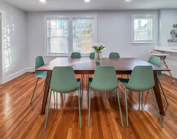 a view of a dining room with furniture window and wooden floor