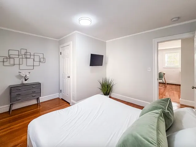 a bedroom with a bed and a flat screen tv