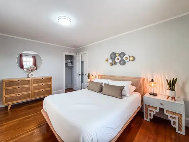 a bedroom with a bed and a dresser