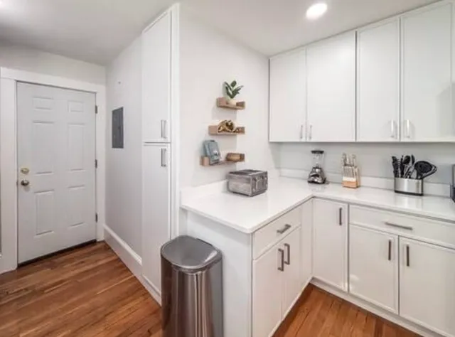 a kitchen with white cabinets and white appliances