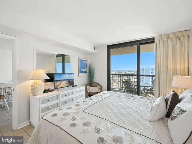 a bedroom with a bed and a large window