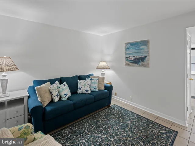 a living room with furniture and a rug