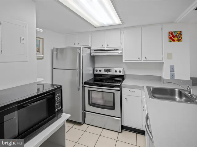 a kitchen with a sink and white cabinets