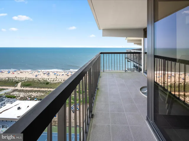 a bedroom with a large bed and a lamp on table