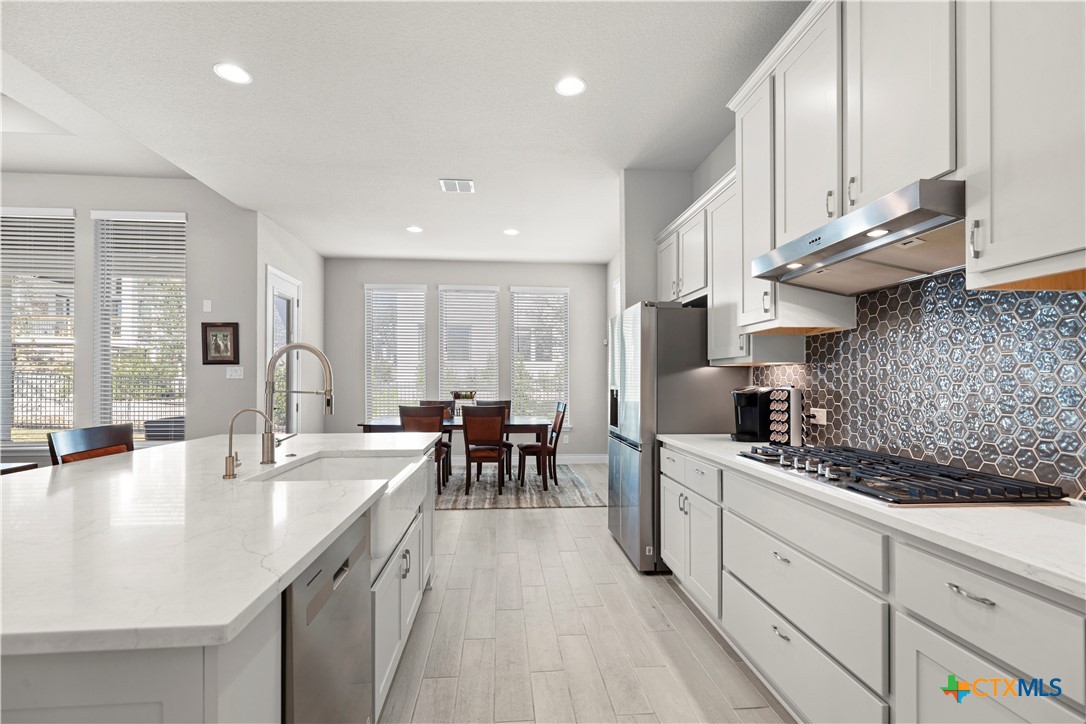 477 Vamanos Boerne, TX 78006 - Photo 12 of 29 a kitchen with sink stove and cabinets