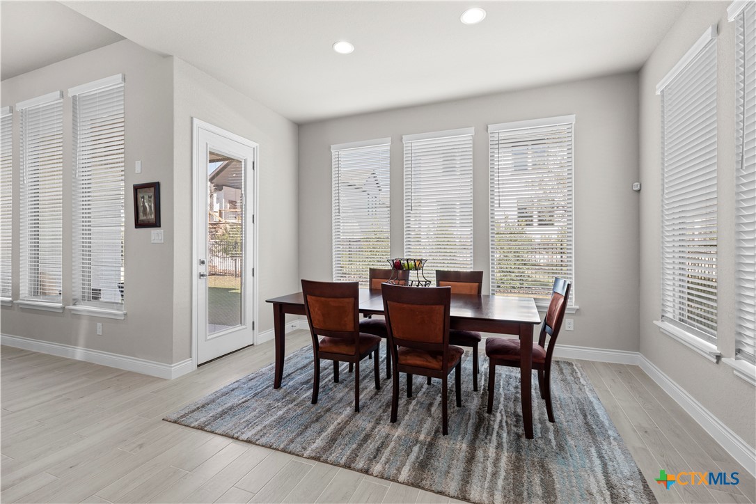 477 Vamanos Boerne, TX 78006 - Photo 13 of 29 a view of a dining room with furniture and wooden floor