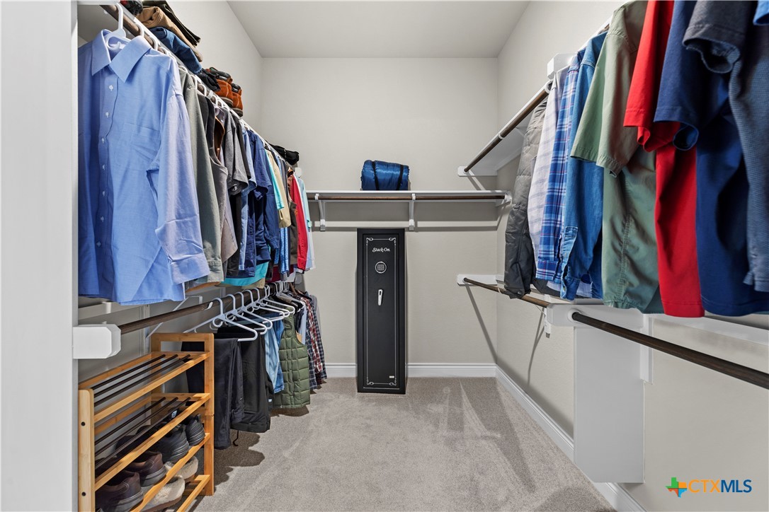 477 Vamanos Boerne, TX 78006 - Photo 19 of 29 a view of walk in closet with clothes and shoes