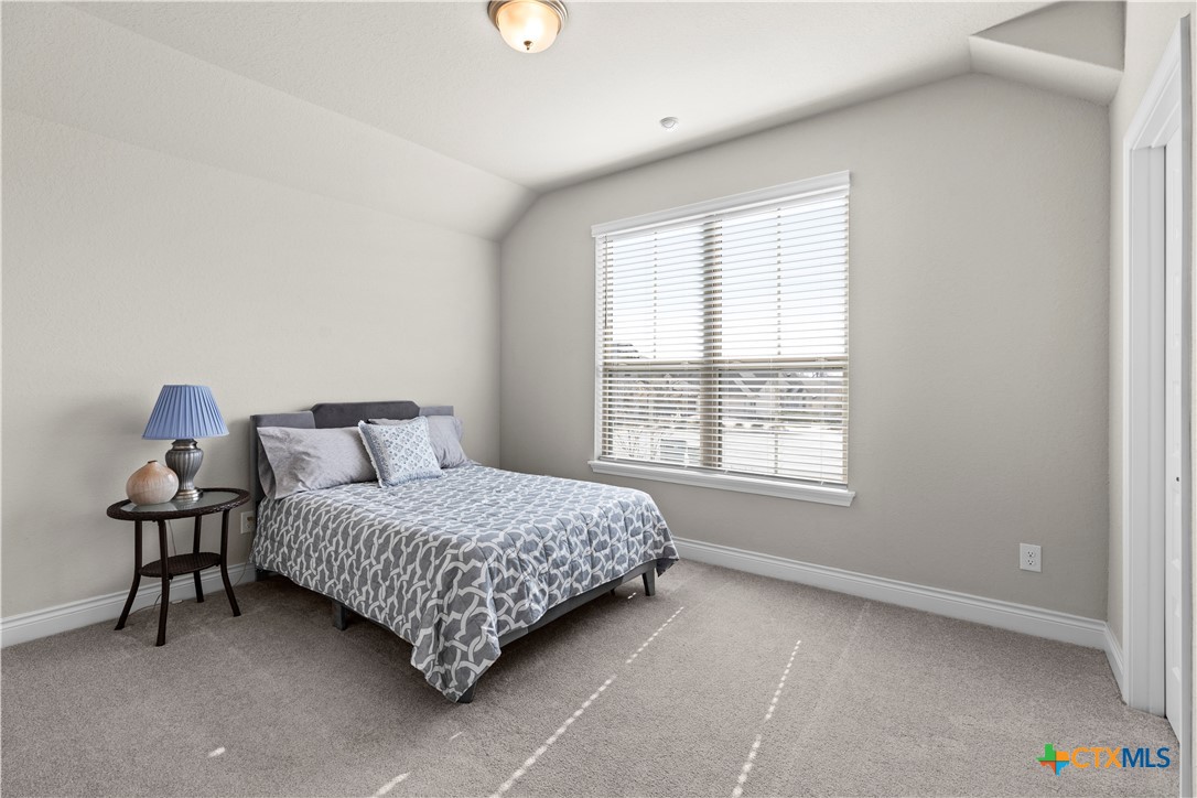 477 Vamanos Boerne, TX 78006 - Photo 20 of 29 a bedroom with a bed and window