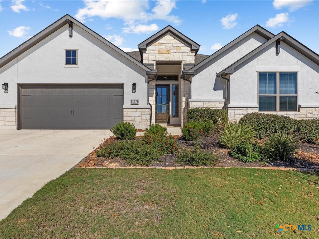 477 Vamanos Boerne, TX 78006 - Photo 2 of 29 a front view of a house with a garden