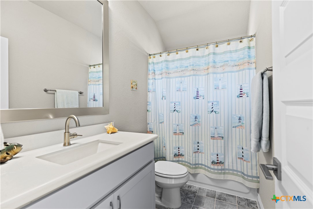 477 Vamanos Boerne, TX 78006 - Photo 23 of 29 a bathroom with a sink toilet a shower and a mirror