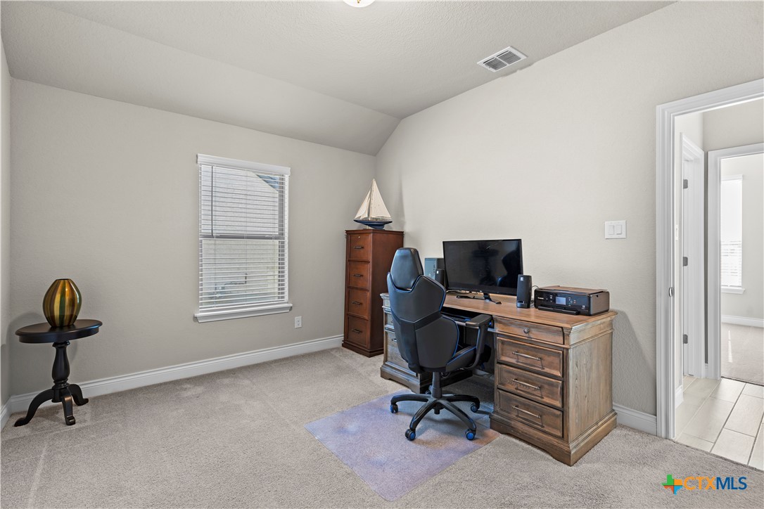 477 Vamanos Boerne, TX 78006 - Photo 25 of 29 a view of a workspace with furniture and a window