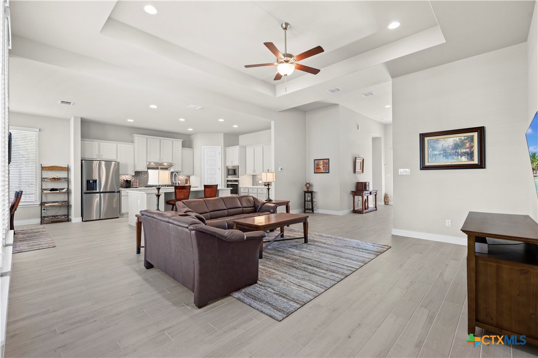 477 Vamanos Boerne, TX 78006 - Photo 9 of 29 a living room with stainless steel appliances kitchen island granite countertop furniture and a view of kitchen