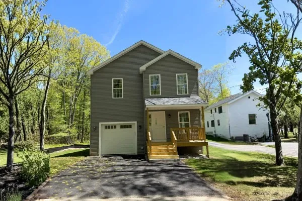 a front view of a house with a yard