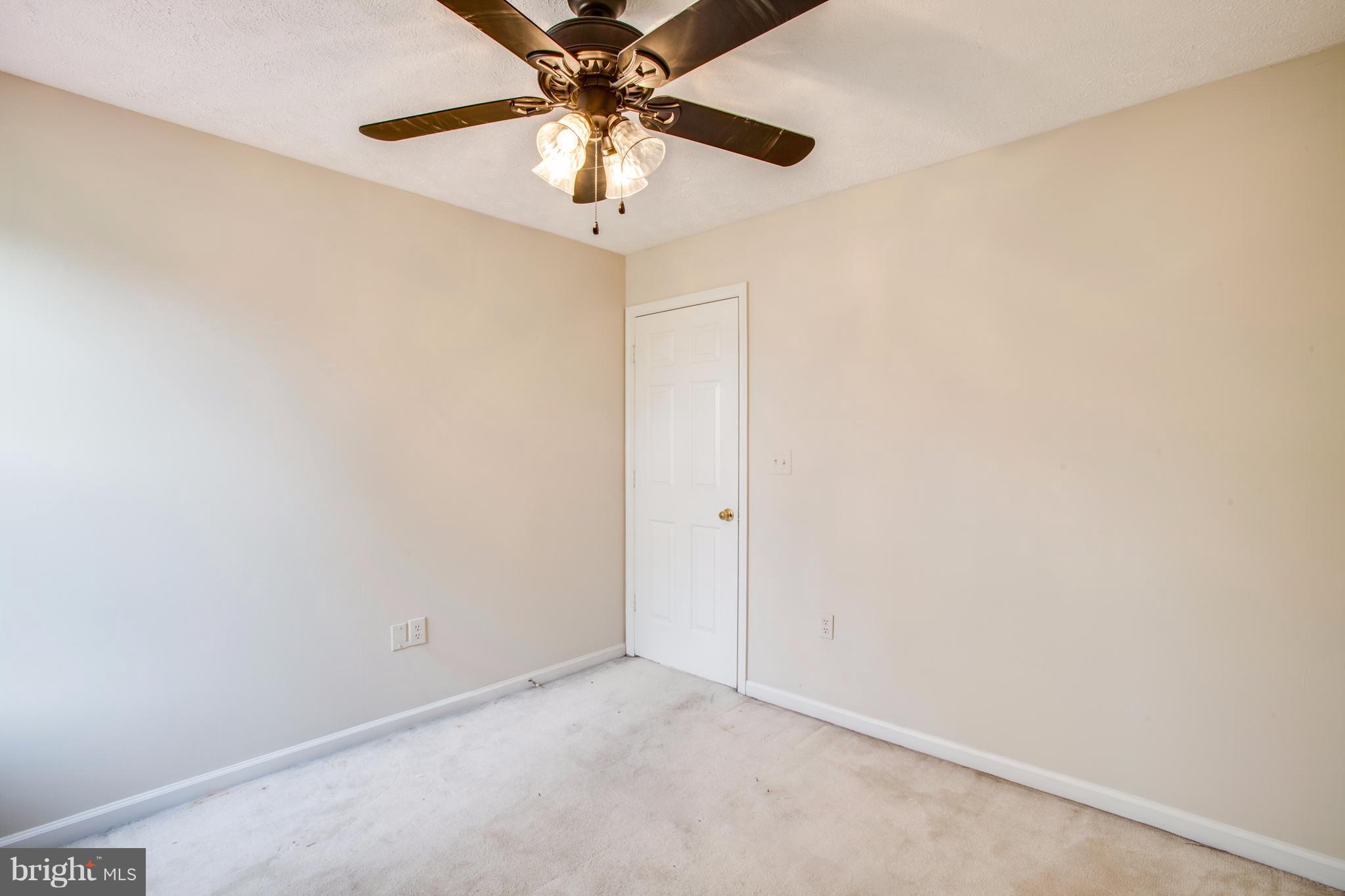 5 Wells Road Stafford, VA 22556 - Photo 18 of 28 an empty room with a chandelier fan