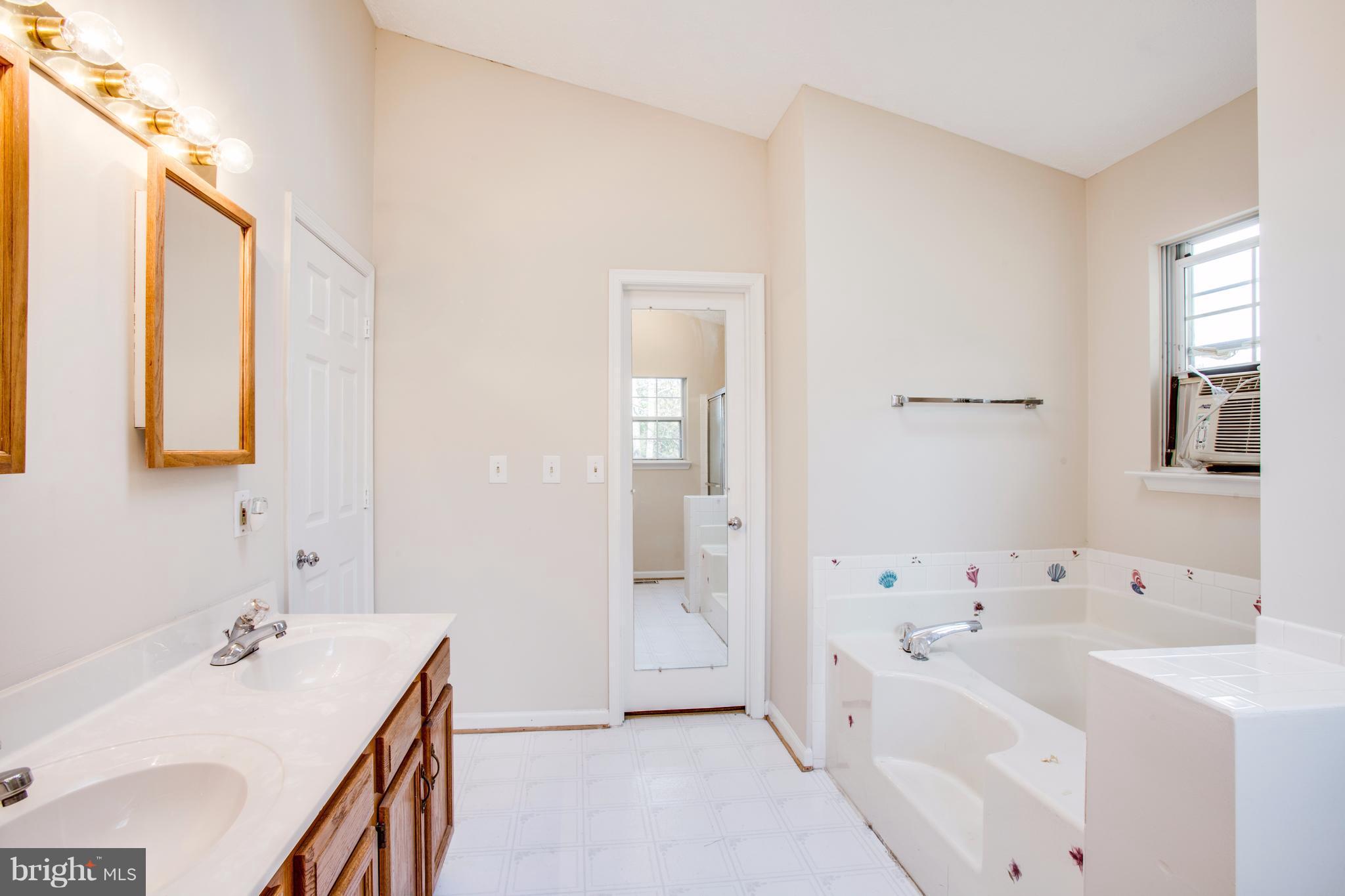 5 Wells Road Stafford, VA 22556 - Photo 23 of 28 a bathroom with a tub sink and mirror