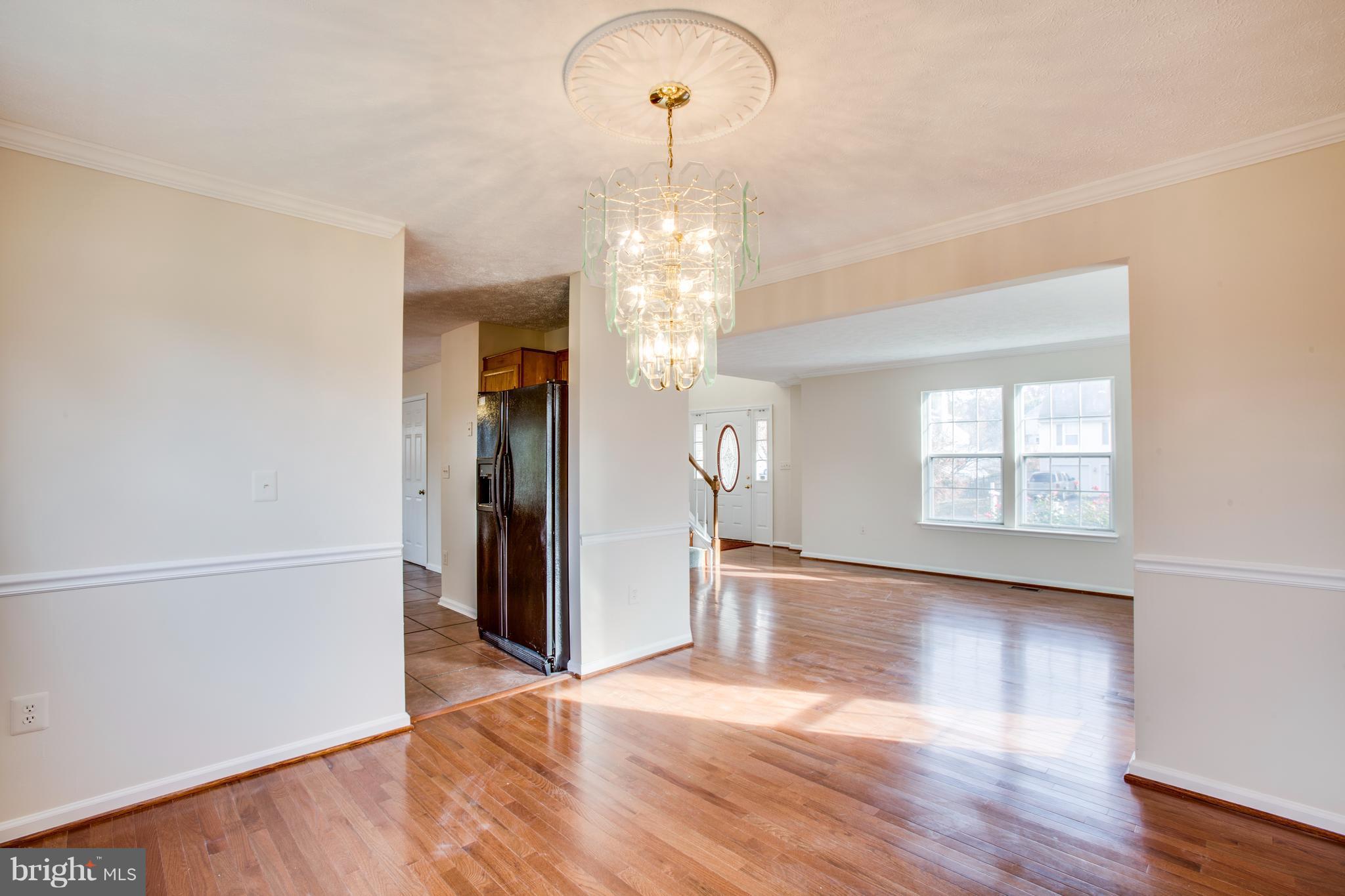 5 Wells Road Stafford, VA 22556 - Photo 6 of 28 a view of a room with wooden floor chandelier and windows