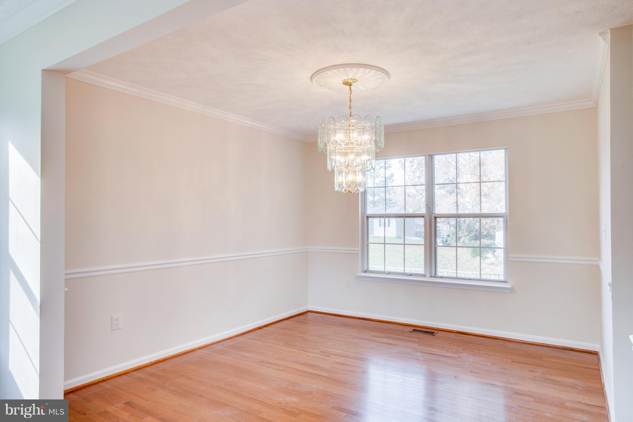 5 Wells Road Stafford, VA 22556 - Photo 7 of 28 an empty room with wooden floor and windows