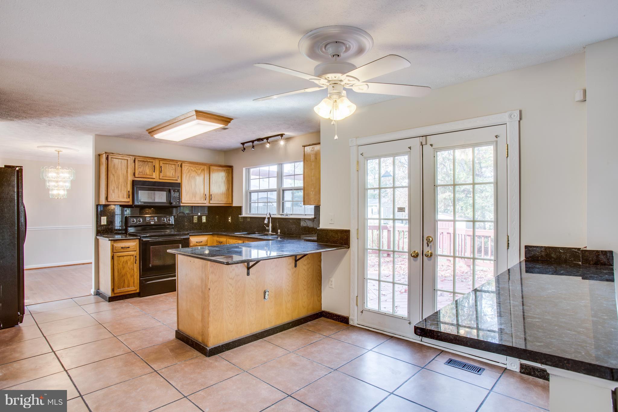 5 Wells Road Stafford, VA 22556 - Photo 9 of 28 a kitchen with stainless steel appliances granite countertop a stove top oven a sink a counter space and cabinets