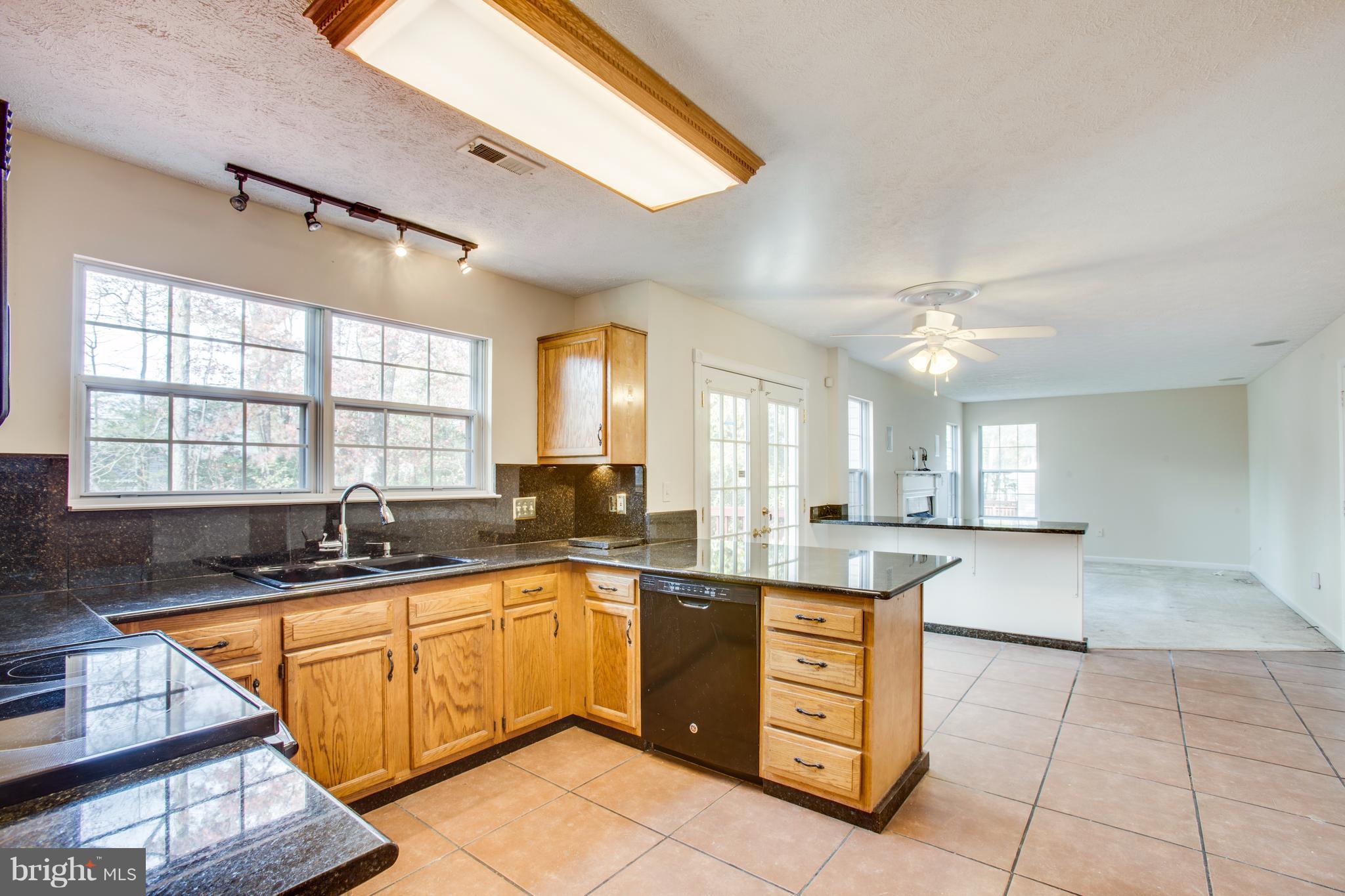 5 Wells Road Stafford, VA 22556 - Photo 10 of 28 a kitchen with stainless steel appliances granite countertop a sink and cabinets