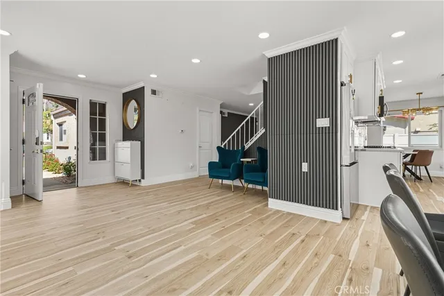 a view of empty room with wooden floor and windows
