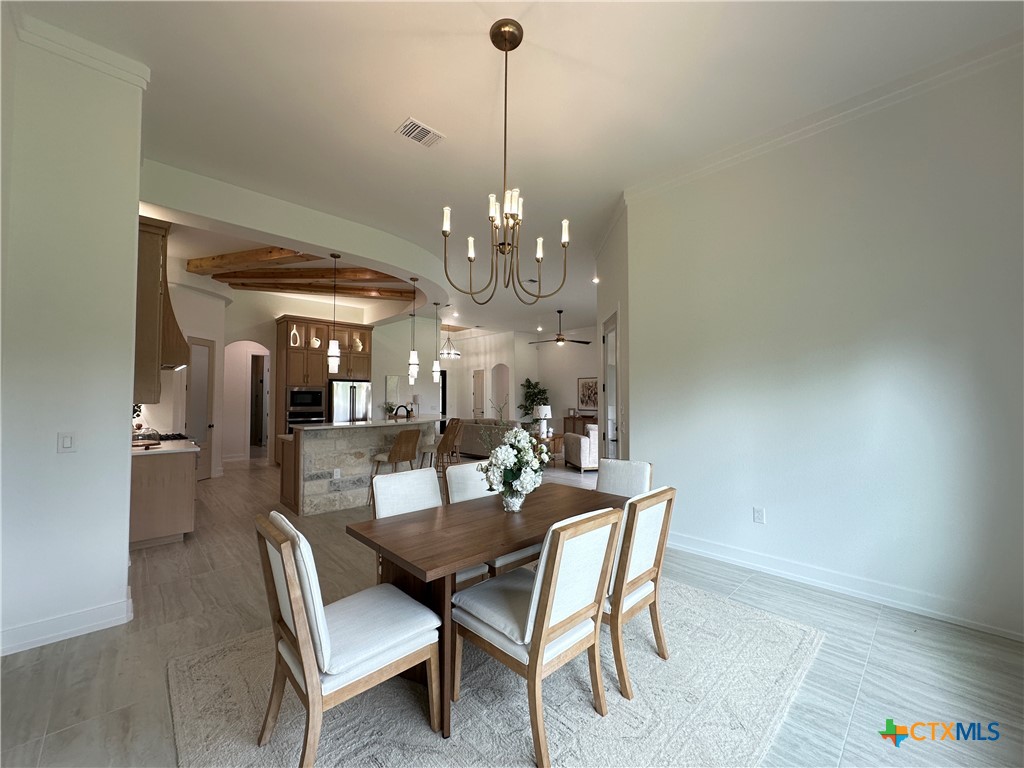 430 Dos Rios Drive Belton, TX 76513 - Photo 15 of 48 a dining room with furniture a chandelier and wooden floor