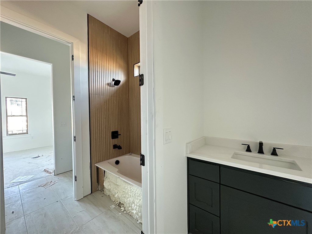 430 Dos Rios Drive Belton, TX 76513 - Photo 16 of 29 a bathroom with a tub shower and mirror