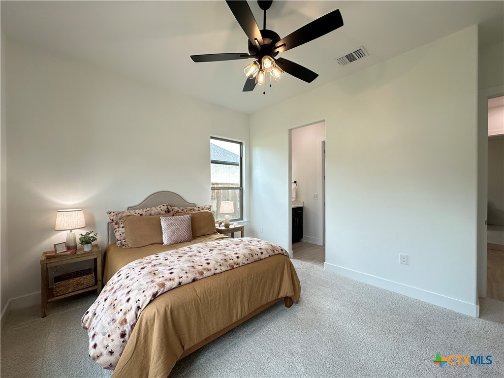430 Dos Rios Drive Belton, TX 76513 - Photo 18 of 48 a bedroom with a bed and a chandelier