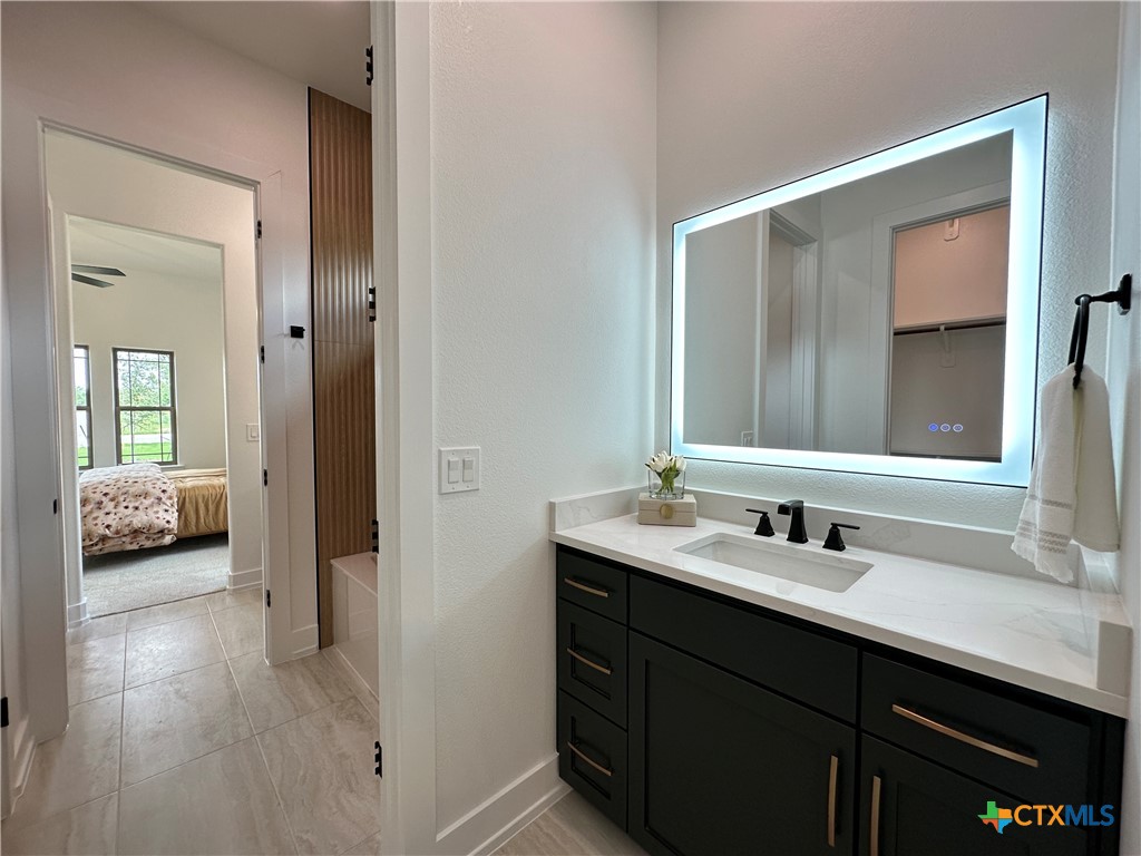 430 Dos Rios Drive Belton, TX 76513 - Photo 23 of 48 a en suite bathroom with a double vanity sink and a mirror